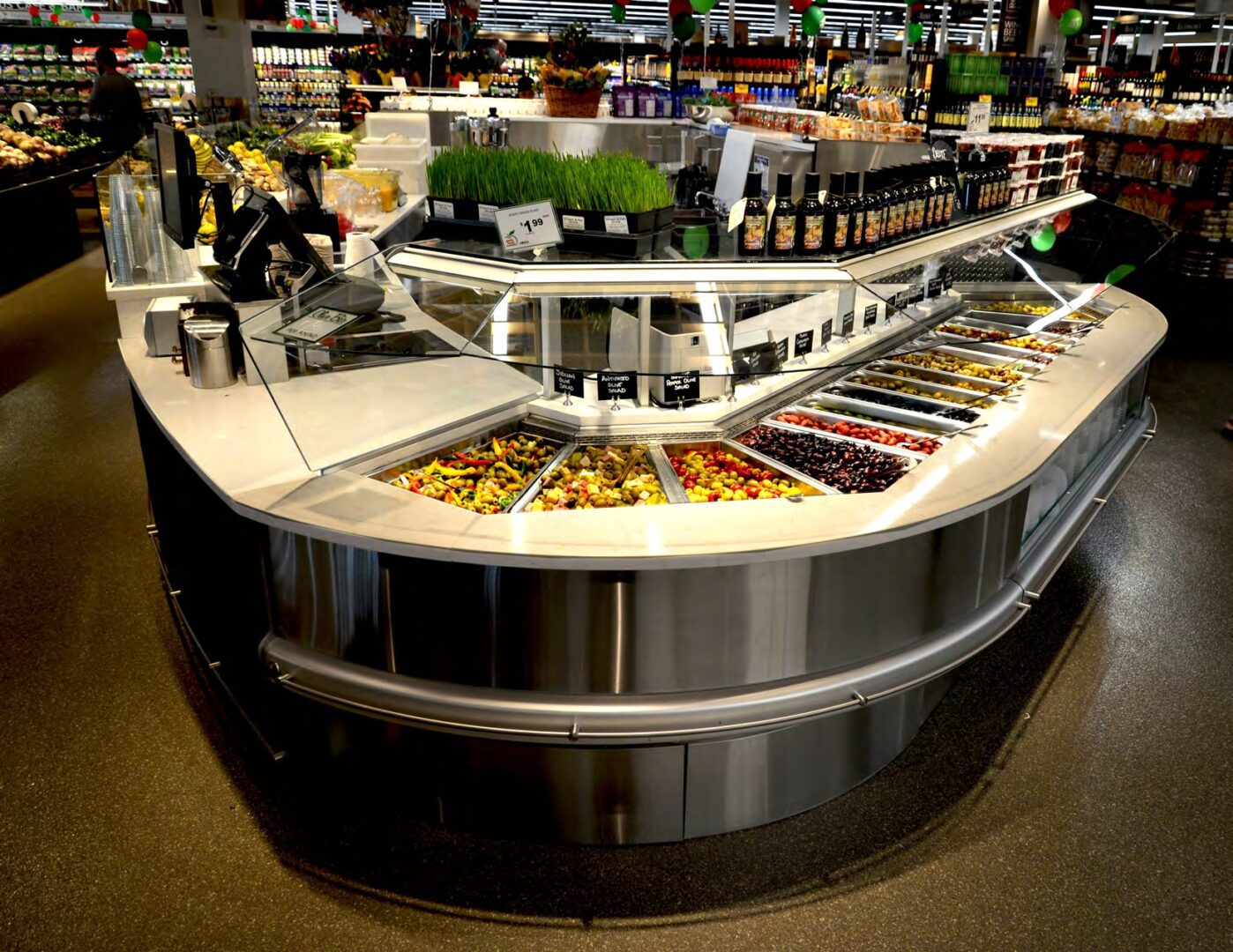 A lighting solution provider enhanced an olive bar with a variety of options in a grocery store.